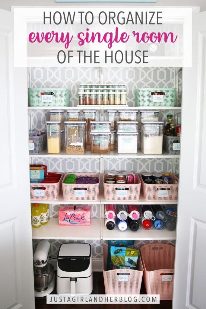 A neatly organized pantry with labeled baskets, bins, and containers holding various food items and kitchen supplies on white shelves.